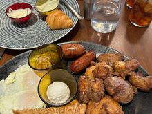 Grand Breakfast Platter from the breakfast and brunch menu, with the remains of a pastry platter in the middle and shakshuka in the background. (The pastry platter was a bit of a disappointment -- clearly not made in-house, unlike everything else we tried.)