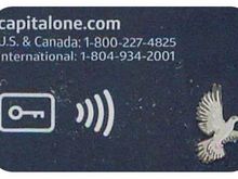 The key provides a one time password to authenticate the card when adding to a phone wallet or verification in the C1 app.   

It is in addition to the tap and pay symbol to the right.  C1 Venture X is the only card I have had with this symbol. 