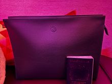 Amenity and pyjamas - passport for scale. It fits a MacBook Air. 