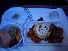Frittata with potato wedges for breakfast. The white cheddar sauce on top was very nice and overall ensured the dish was moist. One of the better egg dishes I have had on a flight.