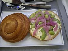 Brioche with egg and mayo topped with fava beans and pickled onions 