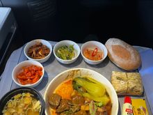 Korean Meal:
Top (left to right): Stir-fried spicy mushrooms, winter cabbage salad with ssamgjang, kimchi, dinner roll.
Middle: Dried sautéed squid with sweet chili 
Bottom: Soybean soup, Grilled beef, rice pack, gochujang and sesame oil packets. 