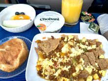 Southwest tortilla scramble - actually pretty damn good. Will get this every time its offered for breakfast. Fruit was fresh but a very small portion. Croissant warm and delicious. The peach yogurt is the worst flavor they have, why cant UA get strawberry, blueberry, banana or something? 