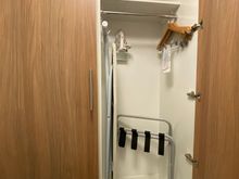 Closet held iron and ironing board