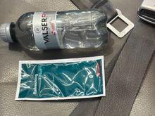 Bottle of water and a wipe next to my seat 