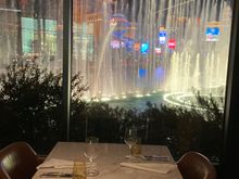 This is a table at the window with full Bellagio  fountain view but from a sideways angle