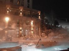Hotel pools at night beside the ski-out