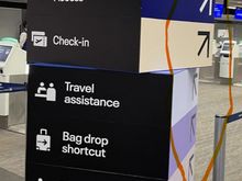 Also, in the photo, you can stand in front of the sign board and see which direction to go, you have to know to angle yourself off to the right.  At first glance I thought all the listed services should proceed to the queue directly in front.  As wayfaring signage this is a fail. 