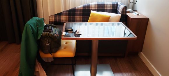 Here's your desk area, with AC and usb easily accessible. Couch more comfortable than it perhaps appears.