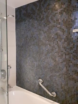 The bath/shower combo- nice tiles but difficult to get into the shower. the  drasin was in the middle of the bath tub, water spilled onto the floor and steamed the whole room in a matter of seconds