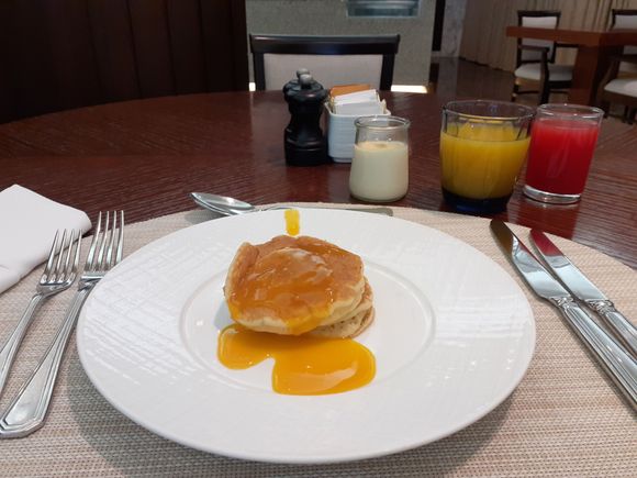 Blueberry pancakes with mango syrup in the restaurant