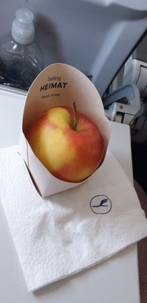 Fresh apples offered alongside chocolates.