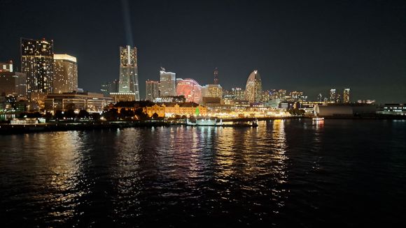 Yokohama at night from roof of  Oshanbashi cruise terminal. Christmas market at  Red brick  buildings