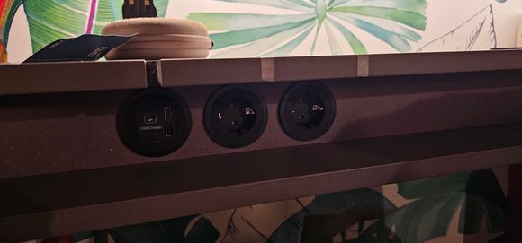 Power sockets under the desk.  Nice bits cut out for power cables