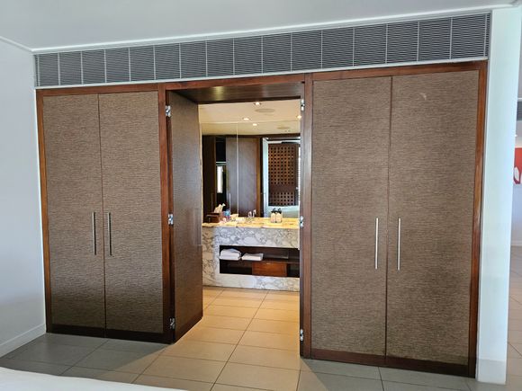 Storage space leading into bathroom
