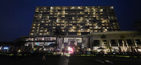 Night-time view of the hotel from the garden