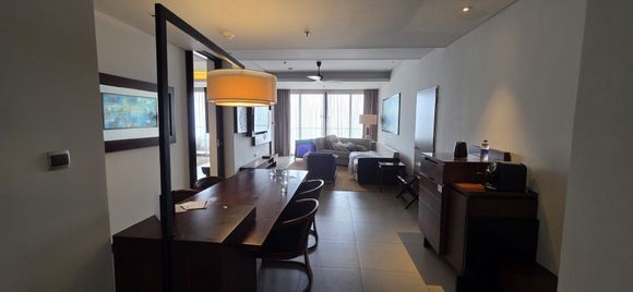 A view of the suite second room with dining table, sofa etc.