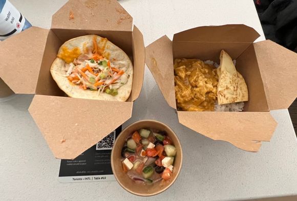 YYZ MLL international  menu - Oct 11, 2021 - Chicken taco, butter chicken, and Greek salad