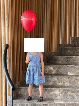 Kids being given a balloon at check-in