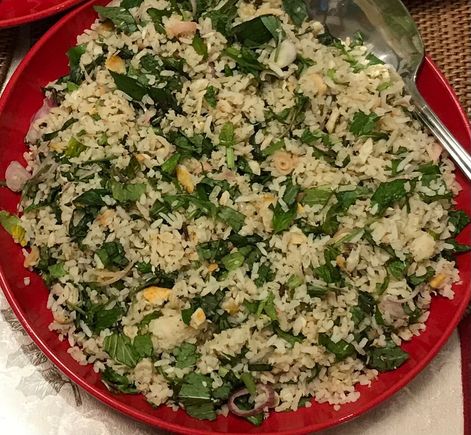 A Peranakan specialty - nasi ulam - rice salad with bits of fish and various herbs . Lovingly prepared by another guy friend .