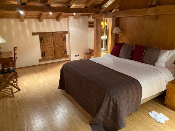 Upstairs master suite — watch your head for those low beams! — with a bed of your dreams.