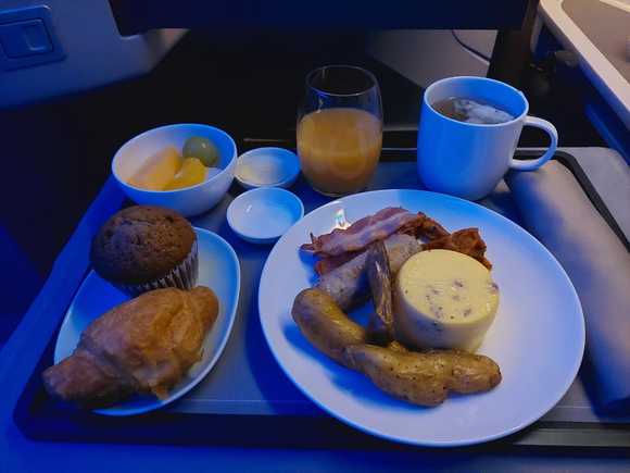 Western breakfast with egg souffle, sausages and potatoes