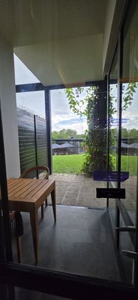 A view from our room towards a small balcony area and then to the pool. Not sure how nice it would be to stay at night here as there are a lot of insects if you leave the lights on
