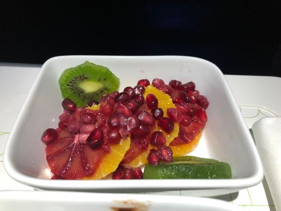 Kiwi, pomegranate seed, blood orange, and orange slices.