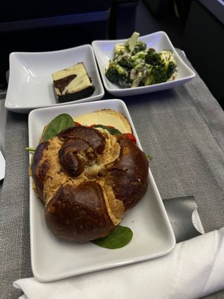 A single piece of cheese, some peppers and some hummus. 