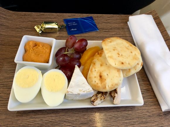 Choice of Roast Beef sandwich with chips or Protein Plate with grilled chicken strips and hummus, pita, egg, grapes, Brie.  Snack basket passed later.  Attentive and friendly service. 