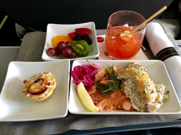 Poached salmon, fresh dill, pickled onion, lemon.  Sour cream chive potato salad. (very tasty)  Side of fruit.  Cinnamon roll.   