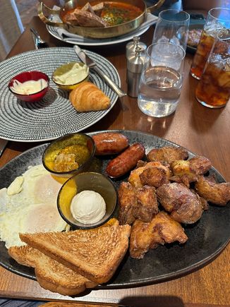 Grand Breakfast Platter from the breakfast and brunch menu, with the remains of a pastry platter in the middle and shakshuka in the background. (The pastry platter was a bit of a disappointment -- clearly not made in-house, unlike everything else we tried.)