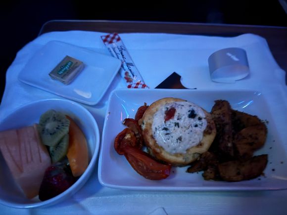 Frittata with potato wedges for breakfast. The white cheddar sauce on top was very nice and overall ensured the dish was moist. One of the better egg dishes I have had on a flight.