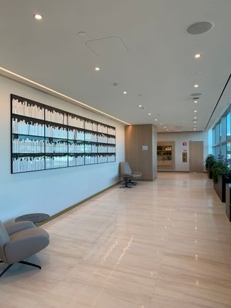 Walkway from entrance to the elevators with tarmac views on one side