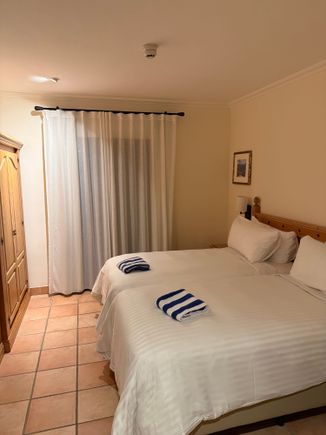 Second bedroom with two beds pushed together.