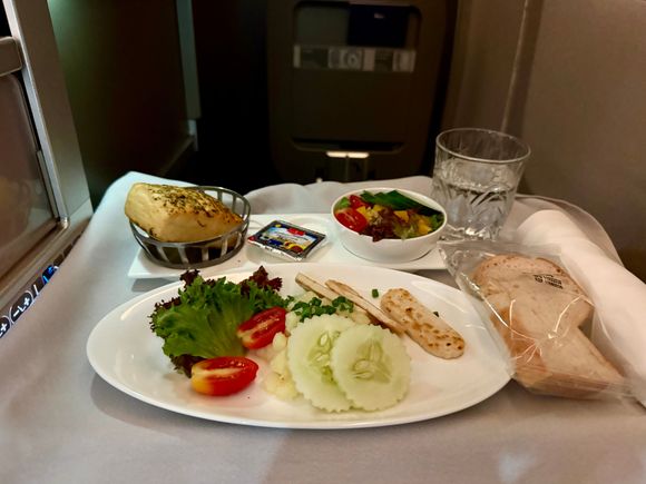 BA2230 BKK-LGW 1st meal starter: salad with tofu slices. Awful. Potato salad had a weird dressing (neither vinegary nor creamy), what I initially was excited about being halloumi turned out to be cold sliced tofu that tasted like cardboard. Served with a side salad, a slice of GF bread, and, very unhelpfully, a regular bread roll <facepalm>