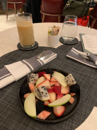 For breakfast: mixed fruit plate with a mango and pineapple smoothie