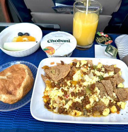 Southwest tortilla scramble - actually pretty damn good. Will get this every time its offered for breakfast. Fruit was fresh but a very small portion. Croissant warm and delicious. The peach yogurt is the worst flavor they have, why cant UA get strawberry, blueberry, banana or something? 