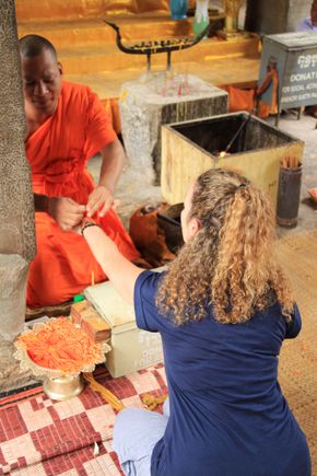 Wife Receiving Blessing From Monk