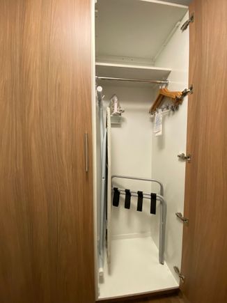 Closet held iron and ironing board