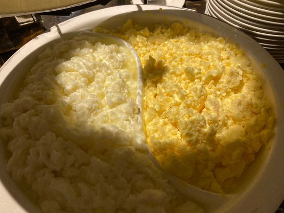 Egg white scrambled next to normal scrambled eggs