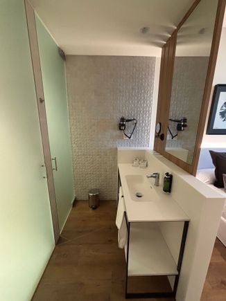 Sink area with shower and toilet in separate cubicles to the left of this picture 