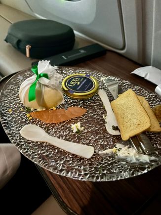 Remnants of prelanding caviar plate #2 (forgot to take a picture of it in its glory and also told the crew they didn’t have to do the whole table set up for it…I’m a simple guy; I can have my caviar off a side table 🙃)