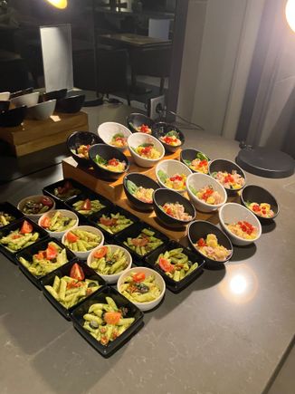 A pasta dish and ham and pineapple salad