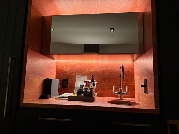 Bar area, with full size fridge in cabinet to the left.