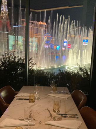 This is a table at the window with full Bellagio  fountain view but from a sideways angle