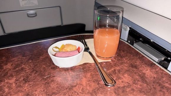 Amuse Bouche: Pastrami ham with fried cheese skewer served after take off.