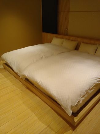 The bedroom with, yes!, two actual double beds.  On the wall opposite the beds is another monster TV set.