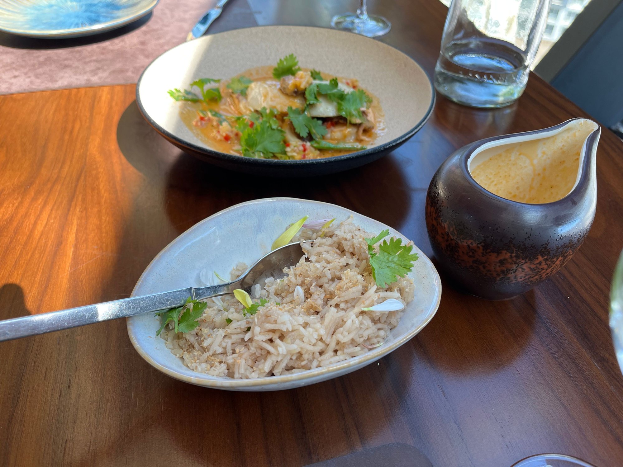 Encocados with black cod, prawns, and squid at the top of the photo, and Kampachi Tiradito with curry 
