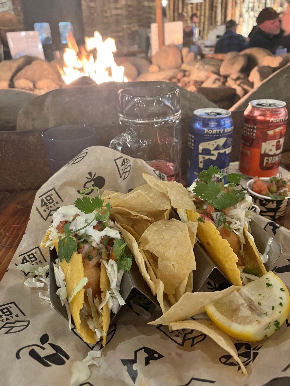 My beer-battered halibut taco; seated in front of a fireplace 